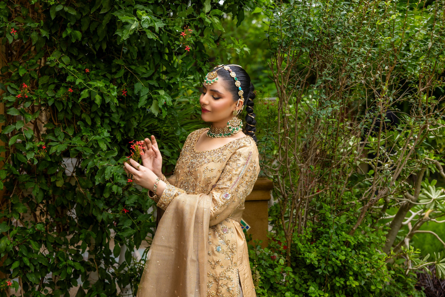 Woman in traditional attire standing in a garden setting